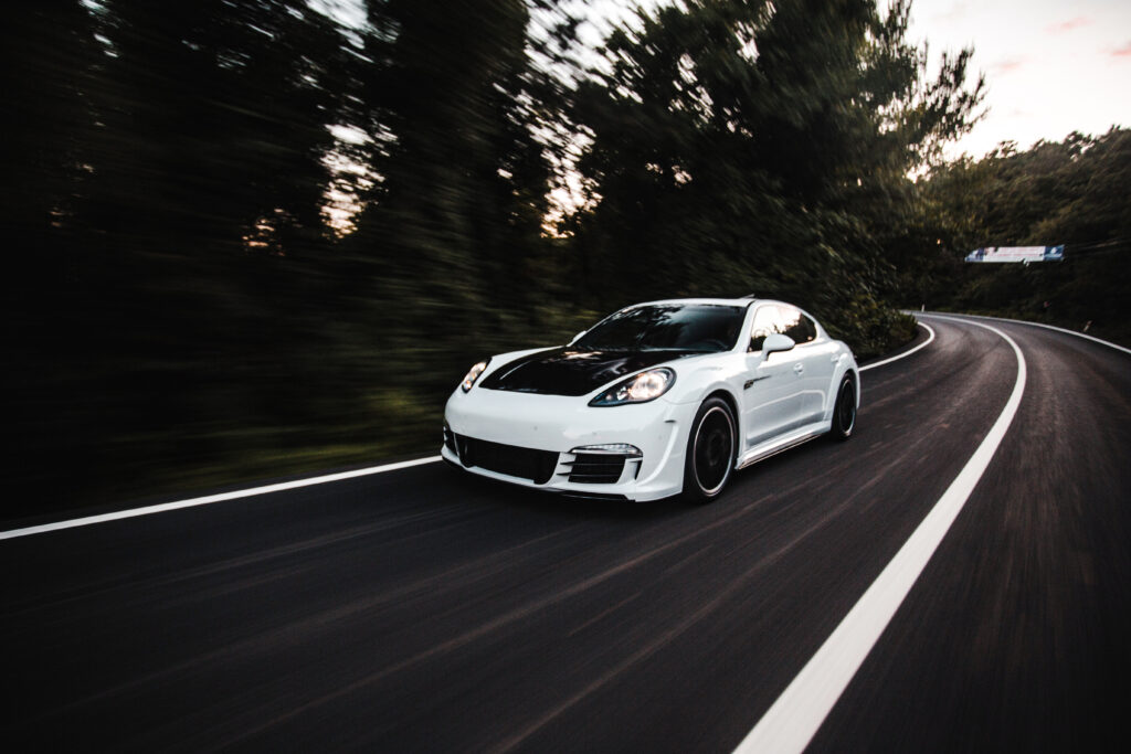 white-sport-car-with-black-autotuning-driving-with-high-speed-road
